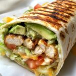 Chicken Avocado Ranch Burrito, displaying a tightly rolled flour tortilla with crispy grill marks