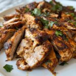 Chicken Shawarma, featuring tender, spiced grilled chicken thighs sliced thin and piled high on a plate