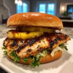 Grilled Hawaiian Chicken Sandwich. A close-up side view of a homemade sandwich with a perfectly grilled chicken breast