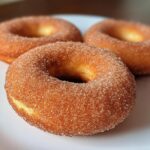 Apple cider donuts with cinnamon sugar coating, soft and warm.