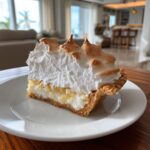 Coconut cream pie with a fluffy, cloud-like topping and rich coconut flavor.