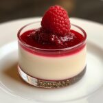 Vanilla bean panna cotta with a drizzle of raspberry coulis, creamy and delicate.