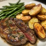 Garlic Butter Steak with crispy potato wedges and green beans