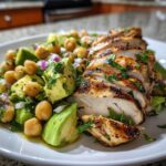 Greek-yogurt marinated chicken served over a fresh avocado-chickpea salad.